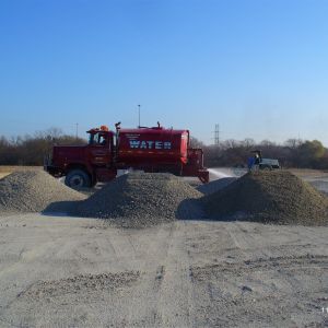 Water truck to prevent release of dust